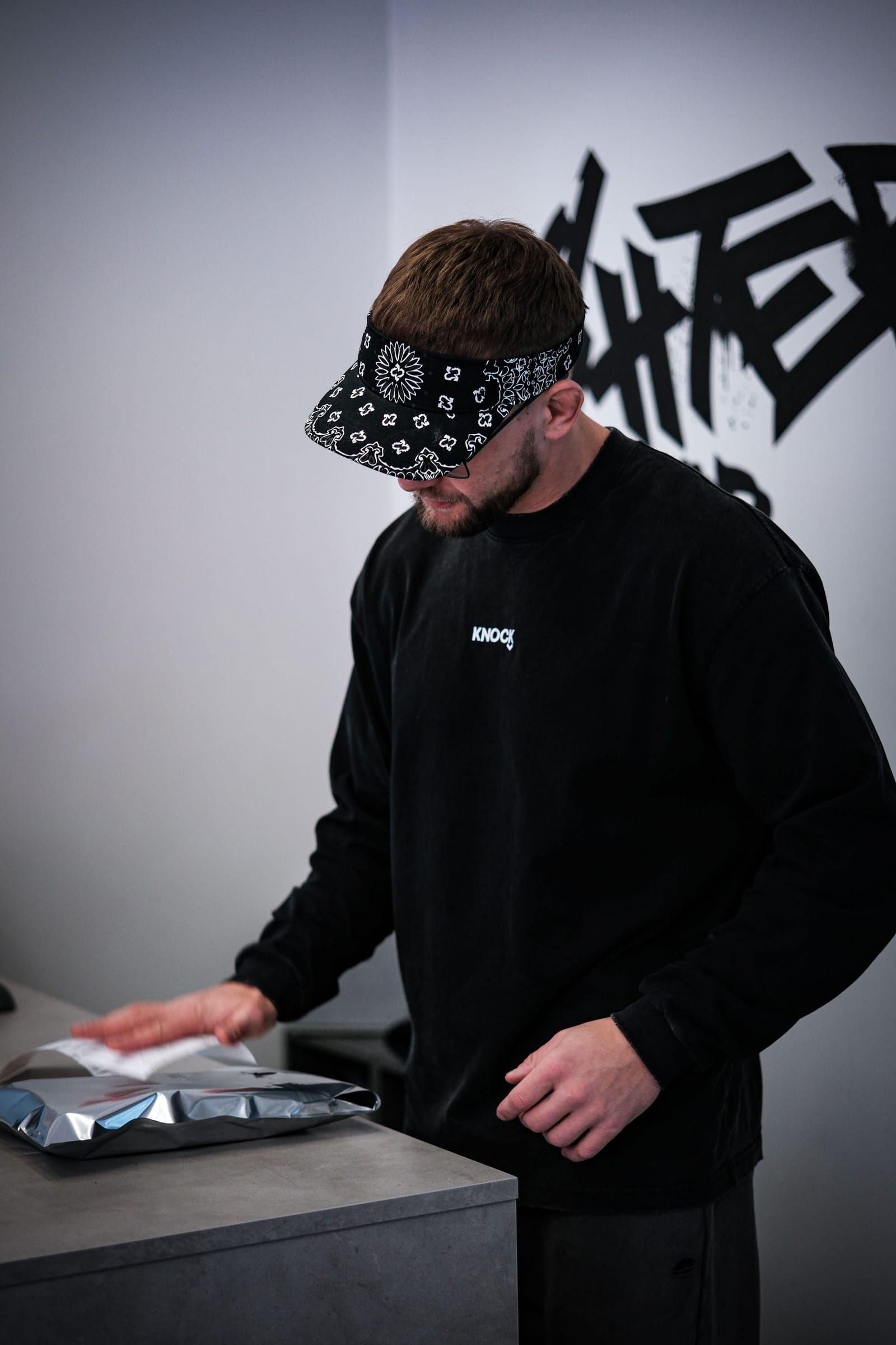 Folding an order into its mailer at the Knock store
