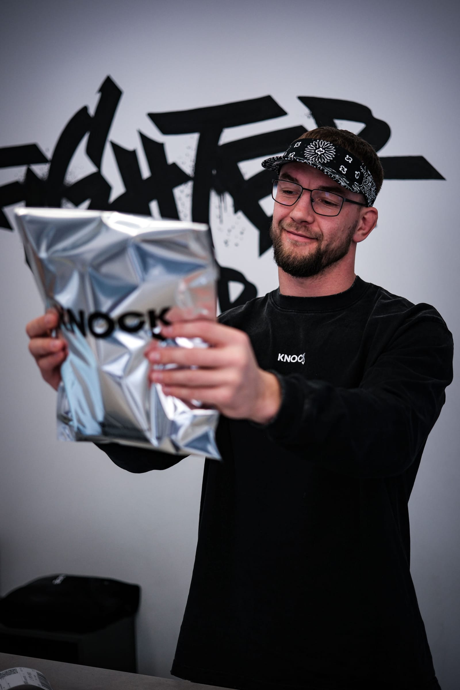 A Knock team member holding a packed order, ready for the courier