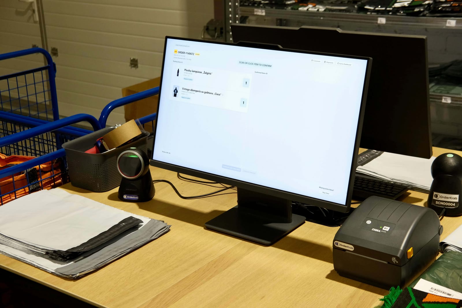 The Žalgiris Shop packing desk with a barcode scanner, screen and label printer