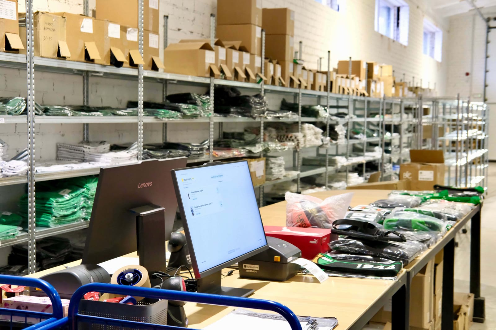 Shelves of Žalgiris merchandise behind the packing desk